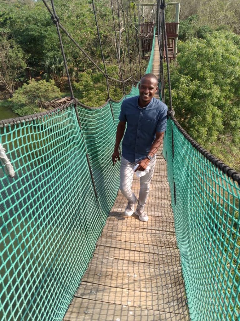 A patron walking on the Canopy Walkway at the Legon Botanical Gardens.