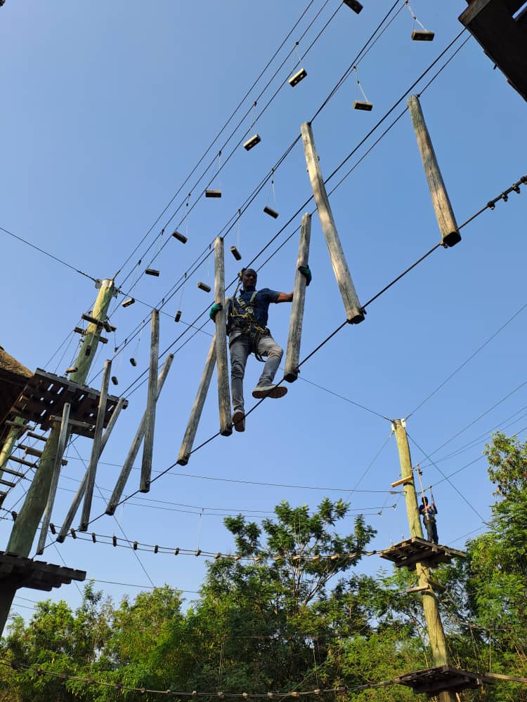 A patron overcoming one of the obstacles in the High Ropes Course at the Legon Botanical Gardens